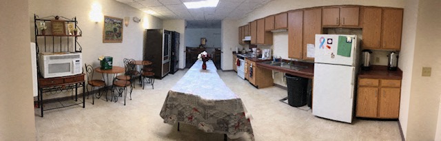 a kitchen with a long table in the middle